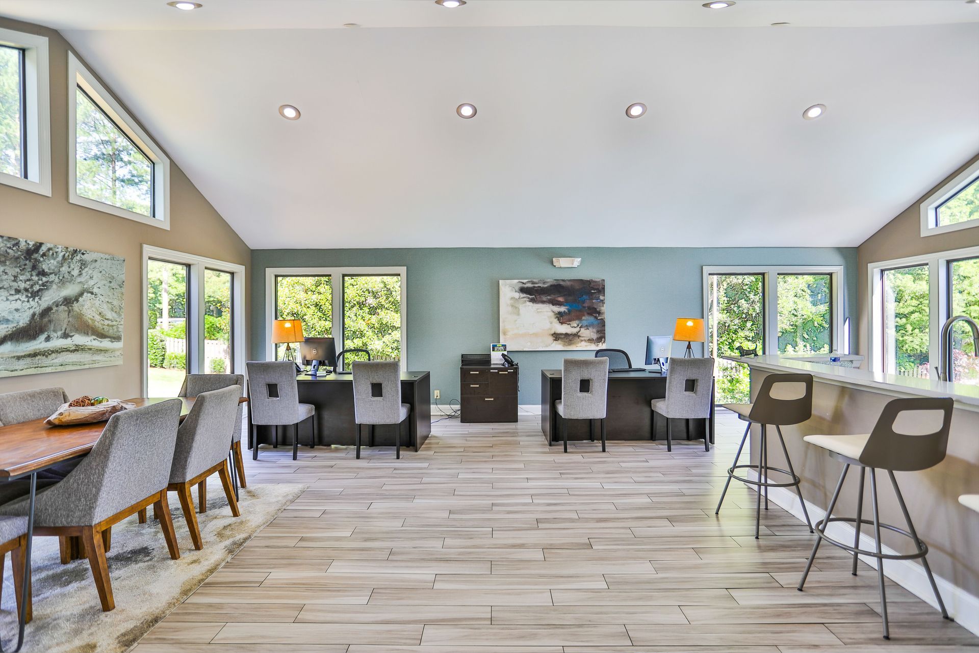 Spacious resident clubhouse with desks, bar seating, and conference table, with large windows overlooking trees. Our apartments in Charlotte, NC offer a convenient location and top-notch amenities. Call today to schedule your tour!