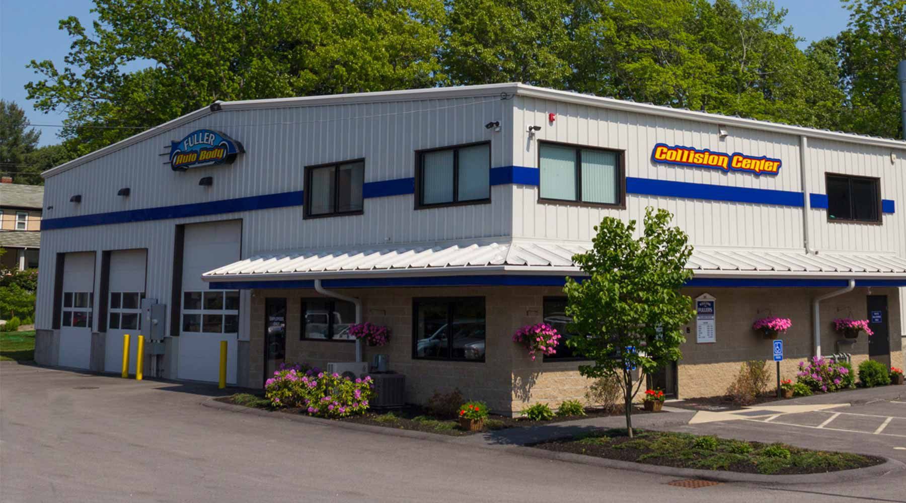 A large white building with the word Collision Center and the Fuller logo on it.
