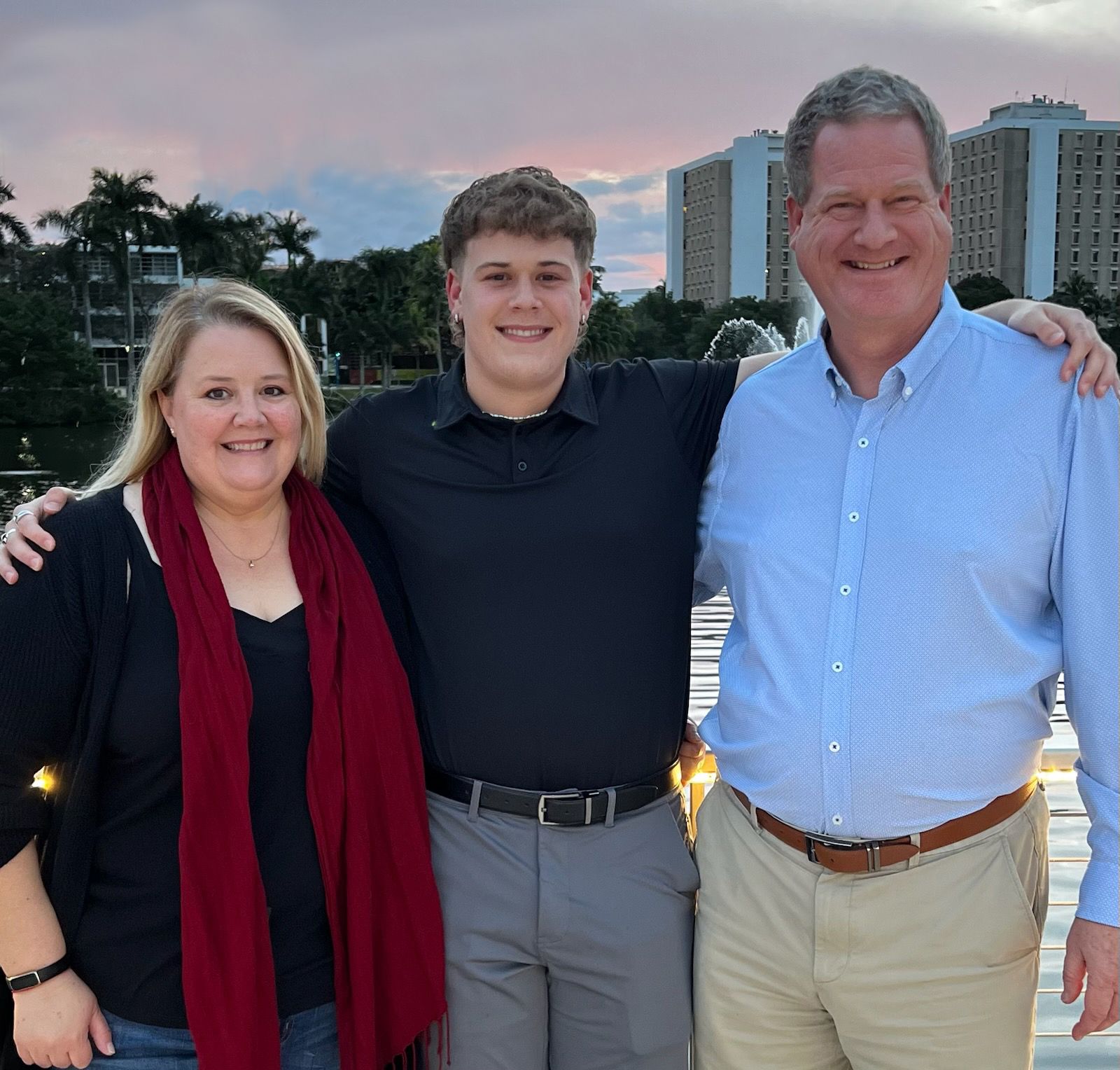 A group family portrait of Michele, Colin, and Brice Gerlach smiling together.