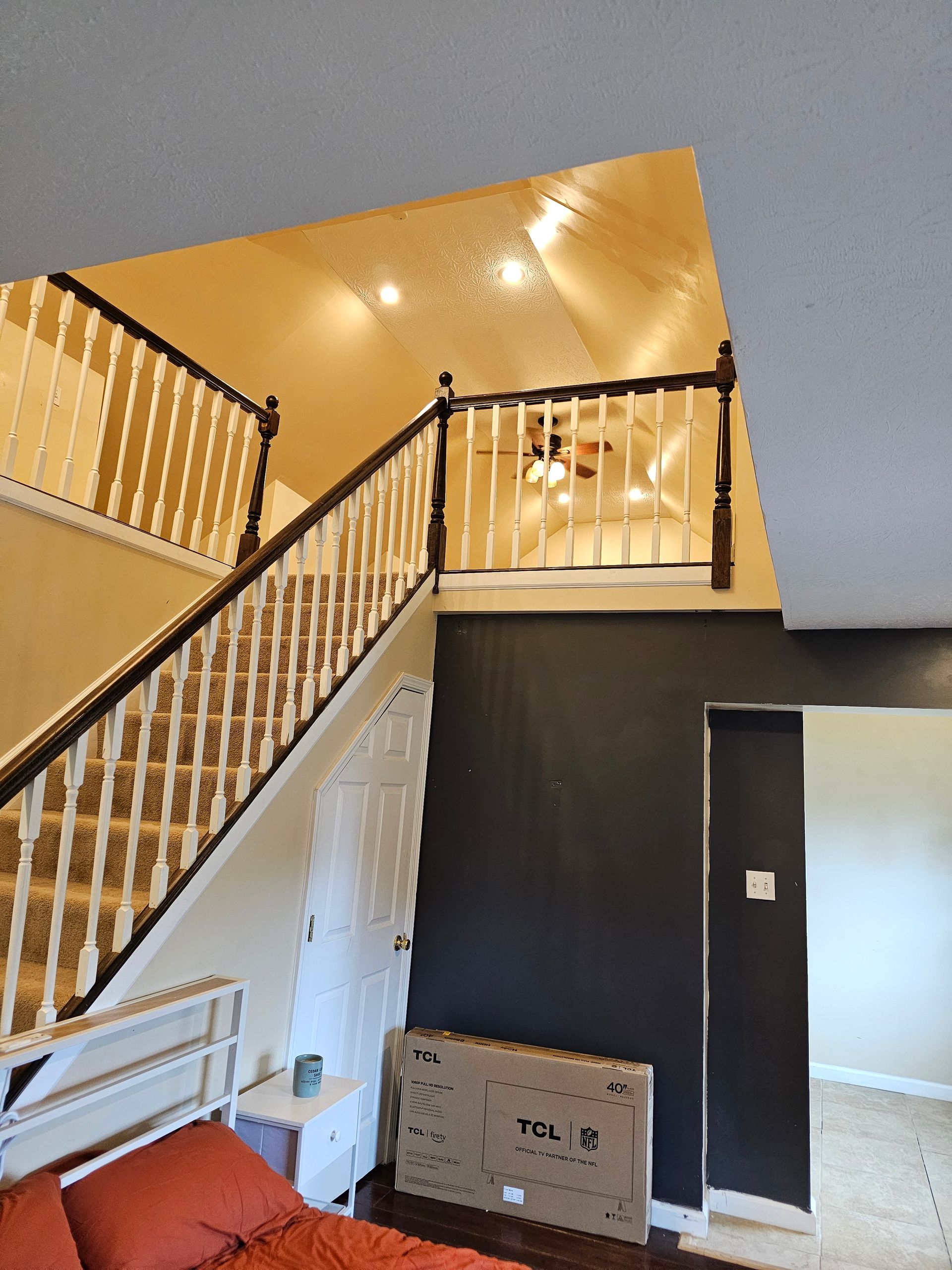 A bedroom with stairs leading up to the second floor