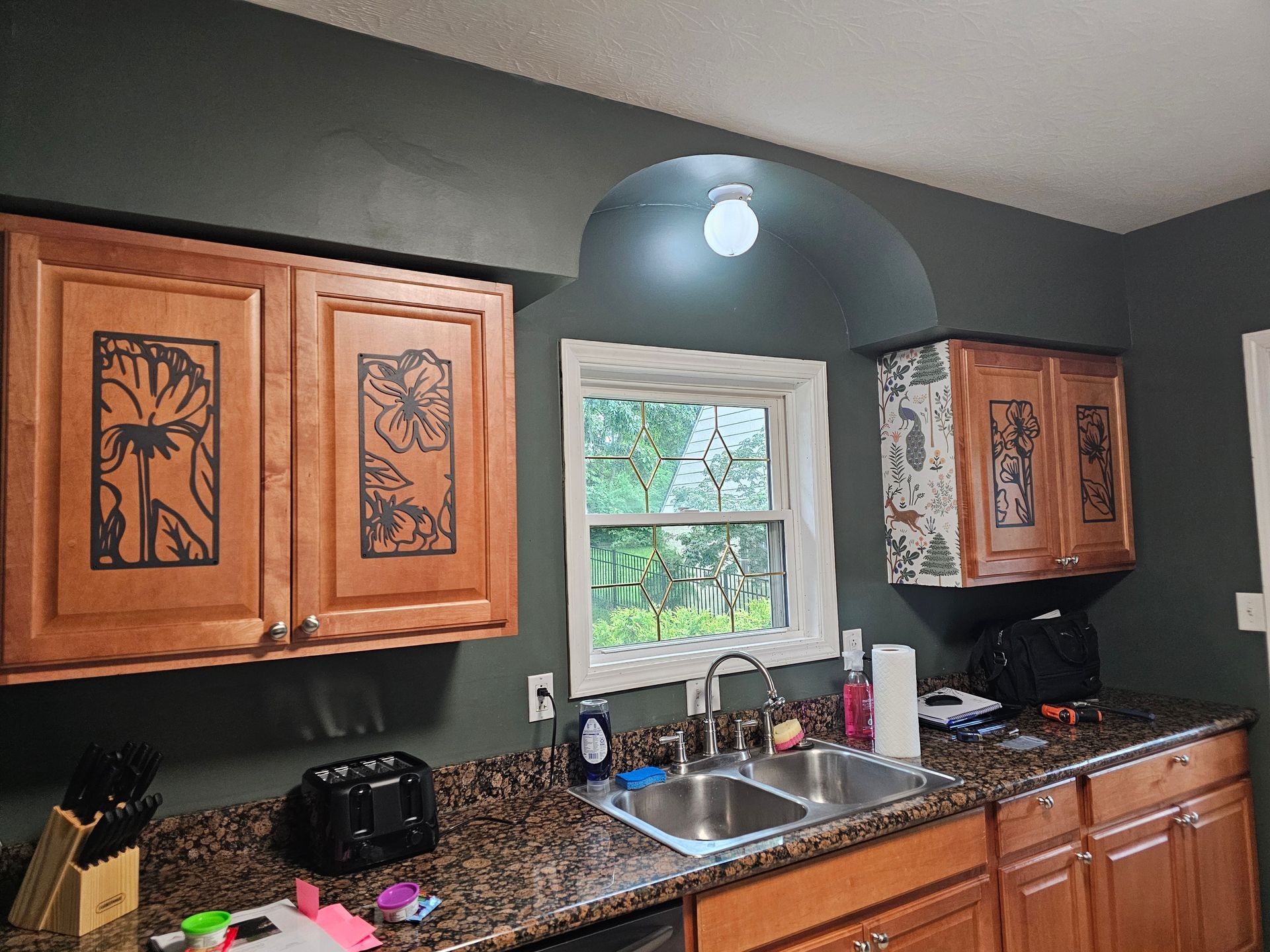 A kitchen with a sink , cabinets and a window