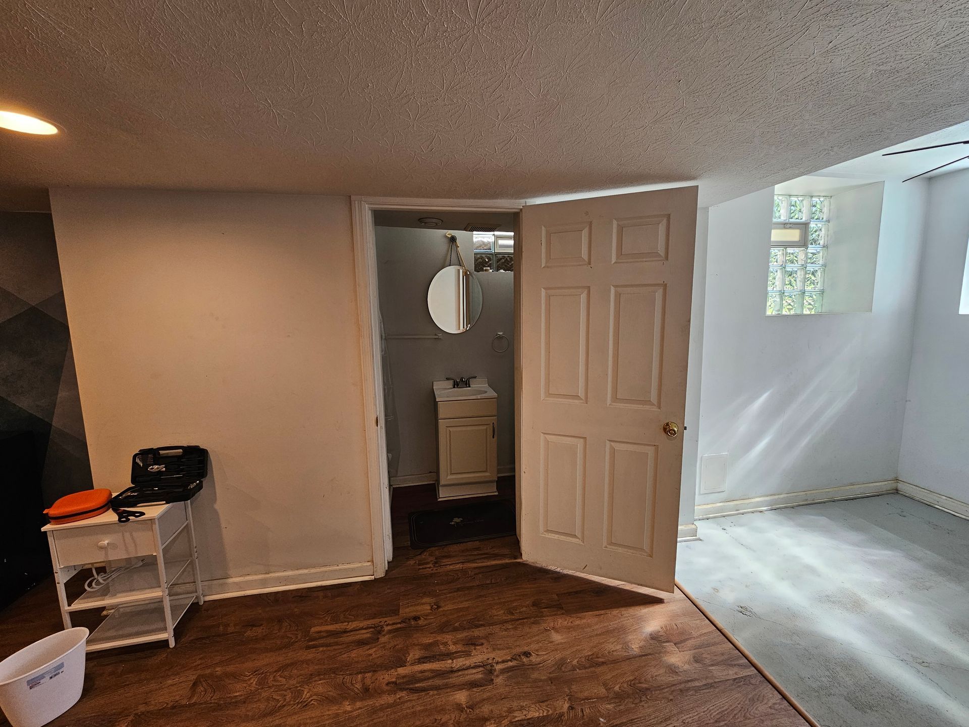 An empty room with a door open to a bathroom.