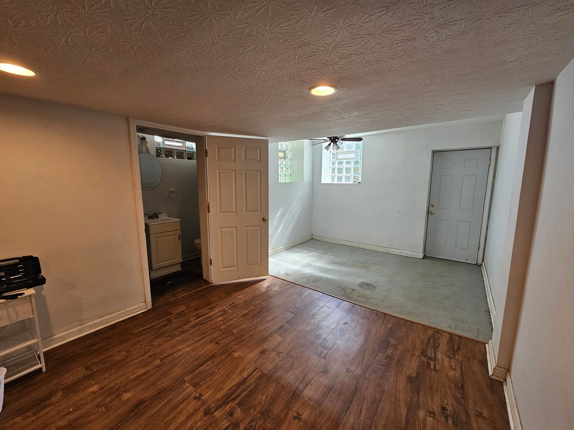 An empty room with hardwood floors and white walls.