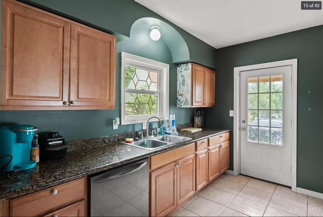 A kitchen with wooden cabinets and granite counter tops
