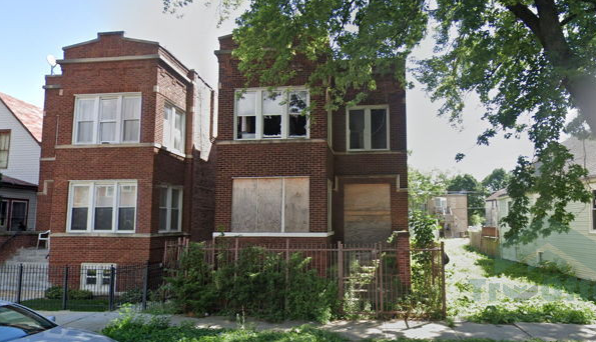 A brick building with a car parked in front of it
