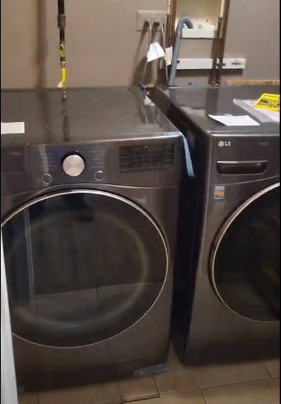 A washer and dryer are sitting next to each other in a laundry room.