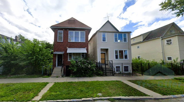 A brick house and a white house are next to each other