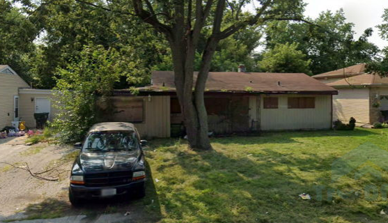 A car is parked in front of a house.