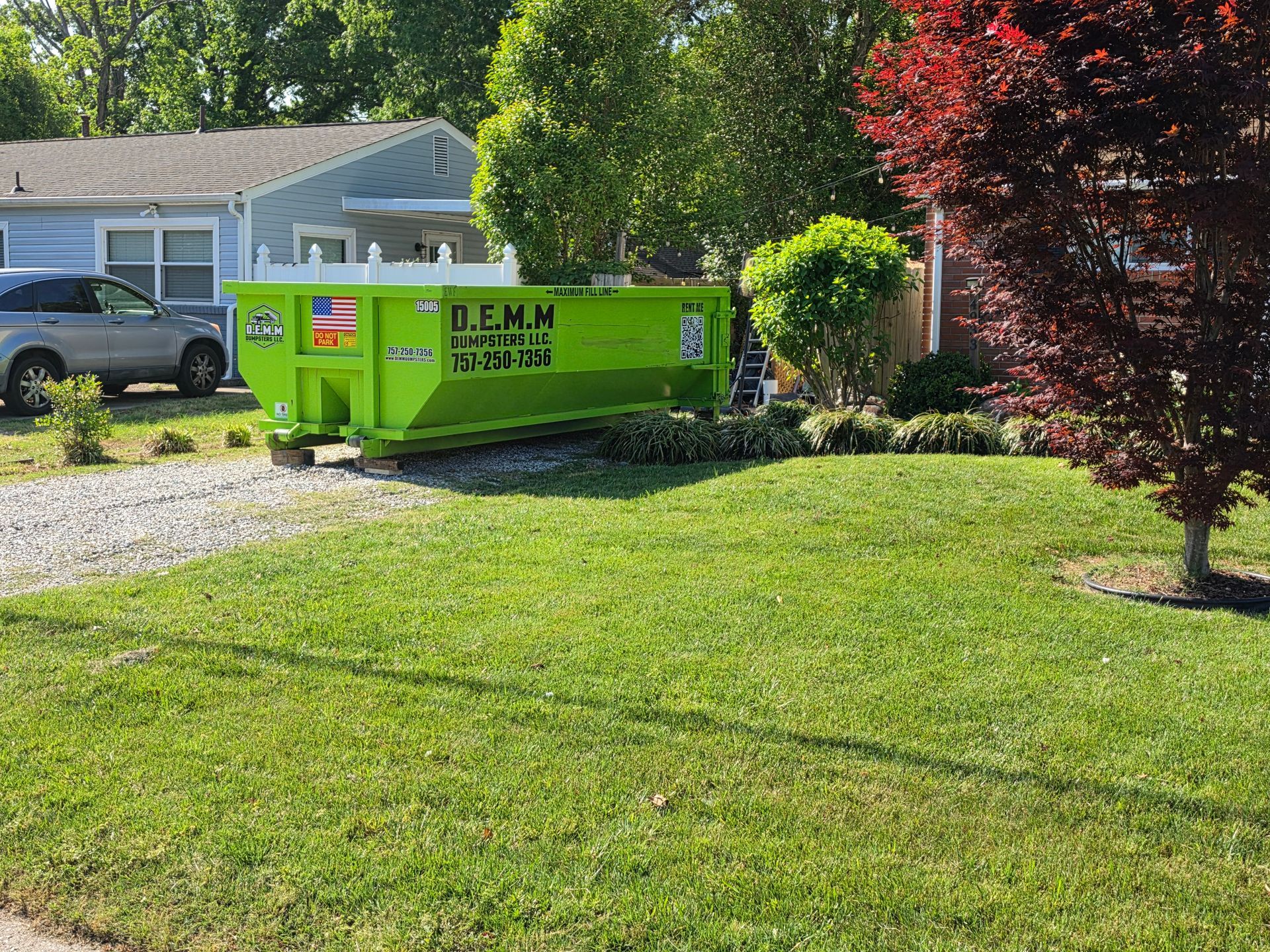 Green D.E.M.M. Dumpsters roll-off delivered for a Suffolk VA jobsite
