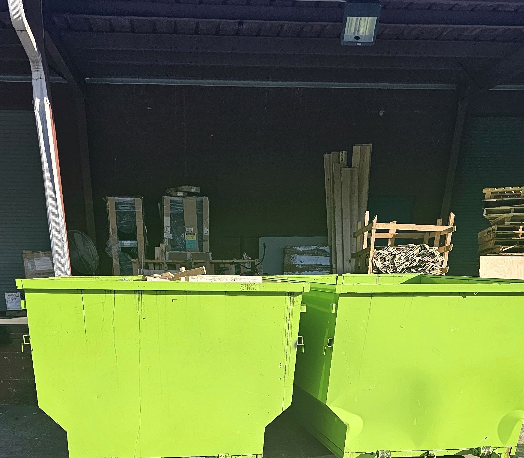 Two D.E.M.M. Dumpsters roll-offs filled with construction debris on a Hampton Roads VA jobsite