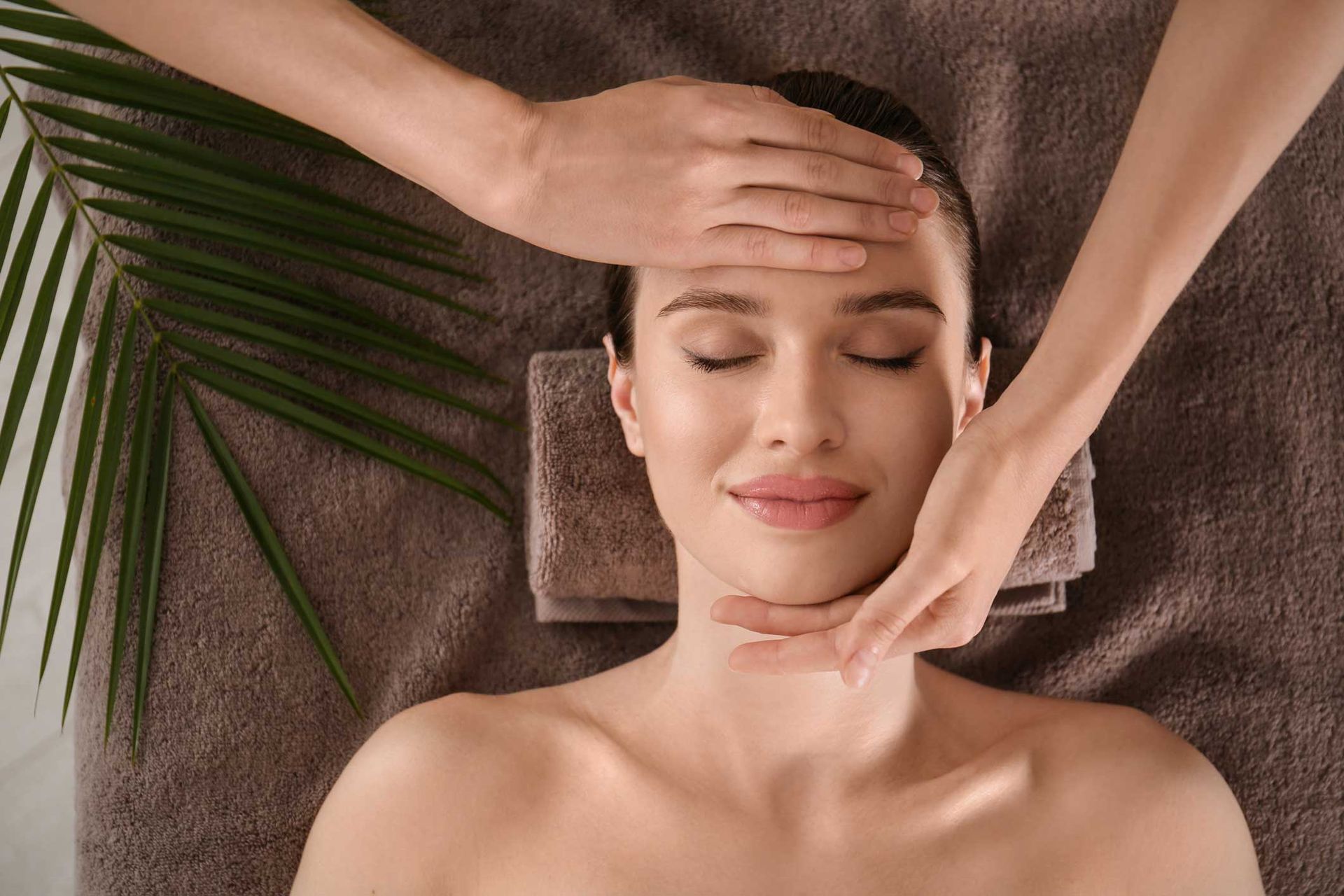 Woman receiving a relaxing facial massage at a wellness spa. Woman receiving a relaxing facial massage at a wellness spa.