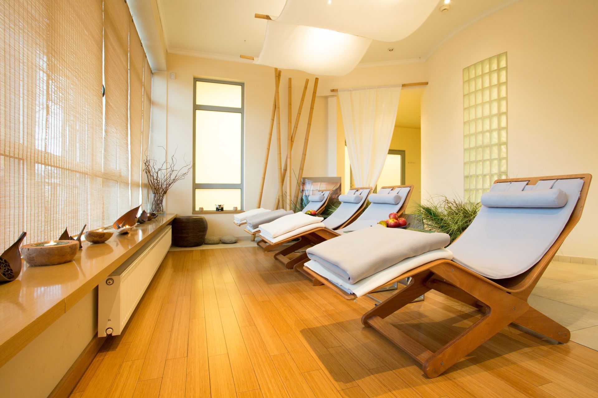 Relaxation lounge with reclining chairs and soft lighting inside a calm, modern wellness center Relaxation lounge with reclining chairs and soft lighting inside a calm, modern wellness center