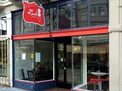 A restaurant with a red sign that says lush on it.