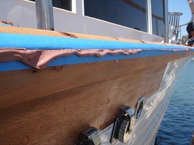 A boat with blue tape on the side of it