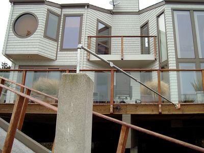 A house with a balcony and stairs leading up to it