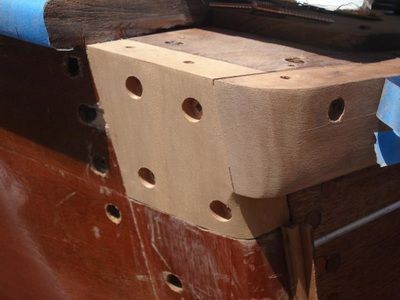 A piece of wood with holes in it is sitting on a table
