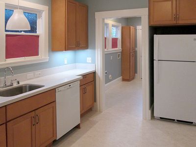 A kitchen with wooden cabinets and a white refrigerator