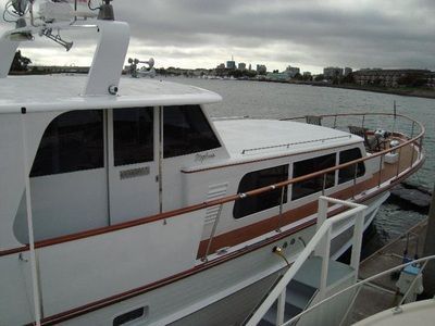 A large white boat is docked in the water