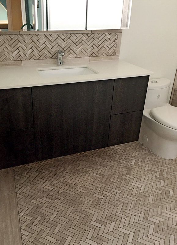 A bathroom with a sink , toilet and mirror.