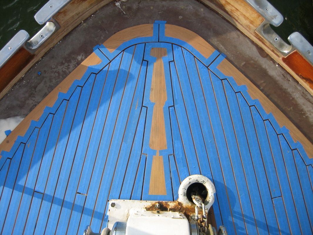 The front of a boat with blue tape on it