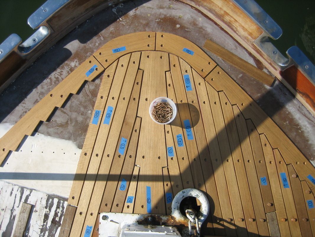 A wooden deck of a boat with a cup of food on it