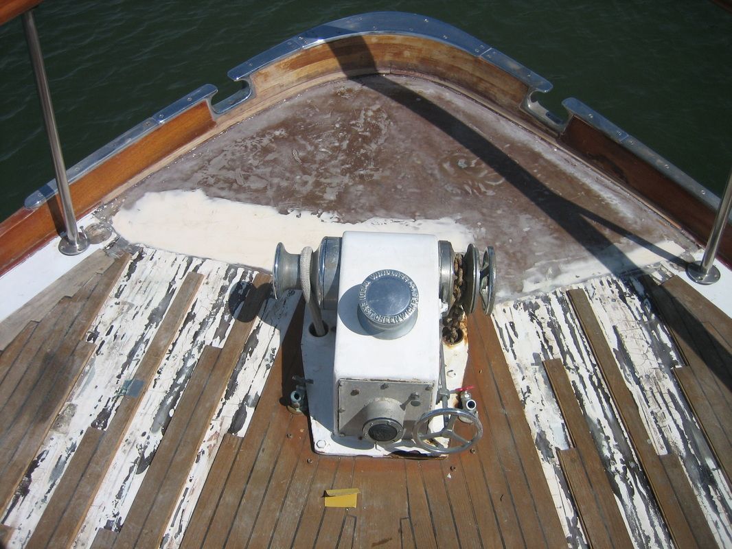 A wooden deck of a boat with a white box on it