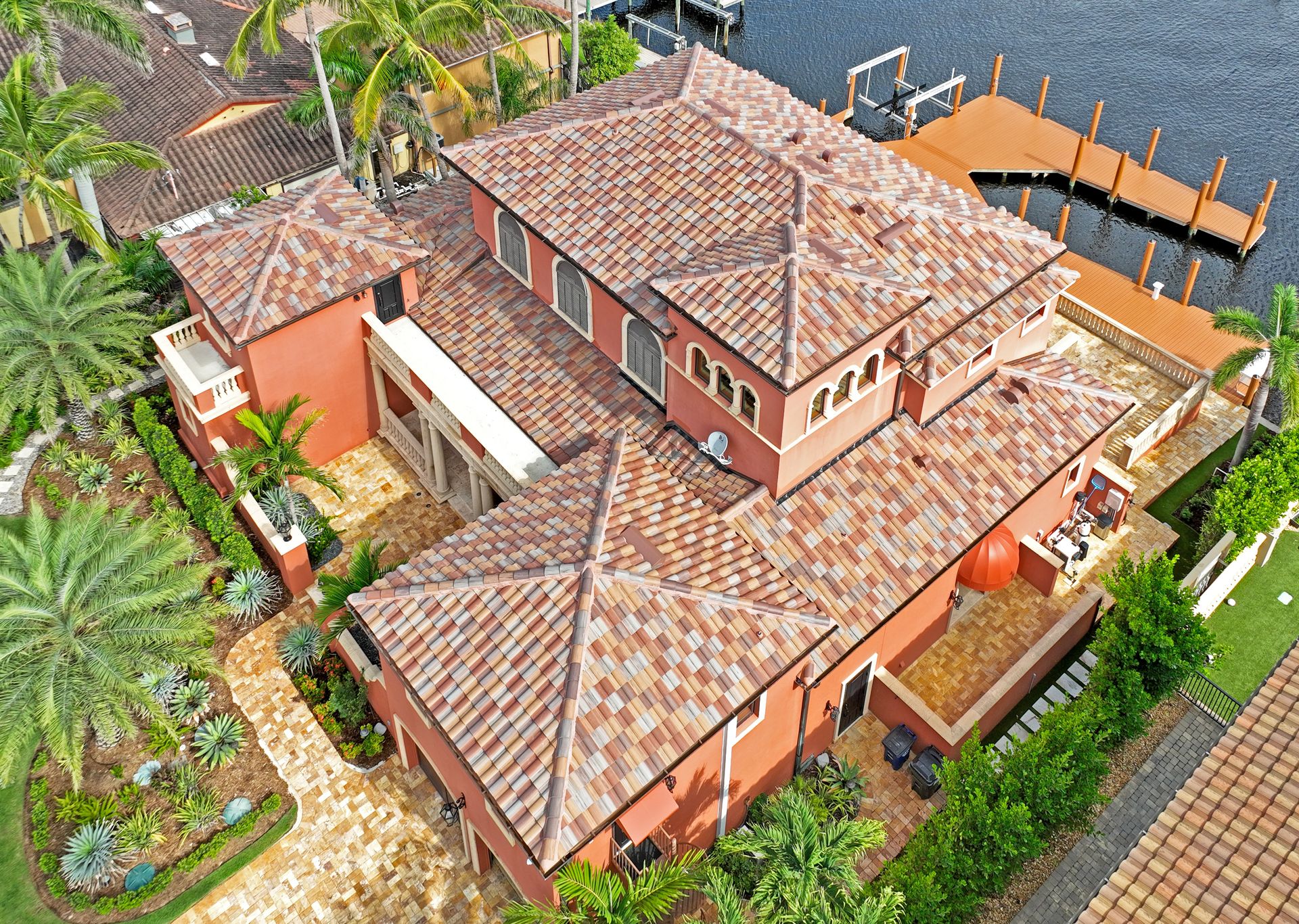 Fort Myers home reroofed with Eagle Capistrano Moss Creek concrete tile and finished with copper gutters and downspouts