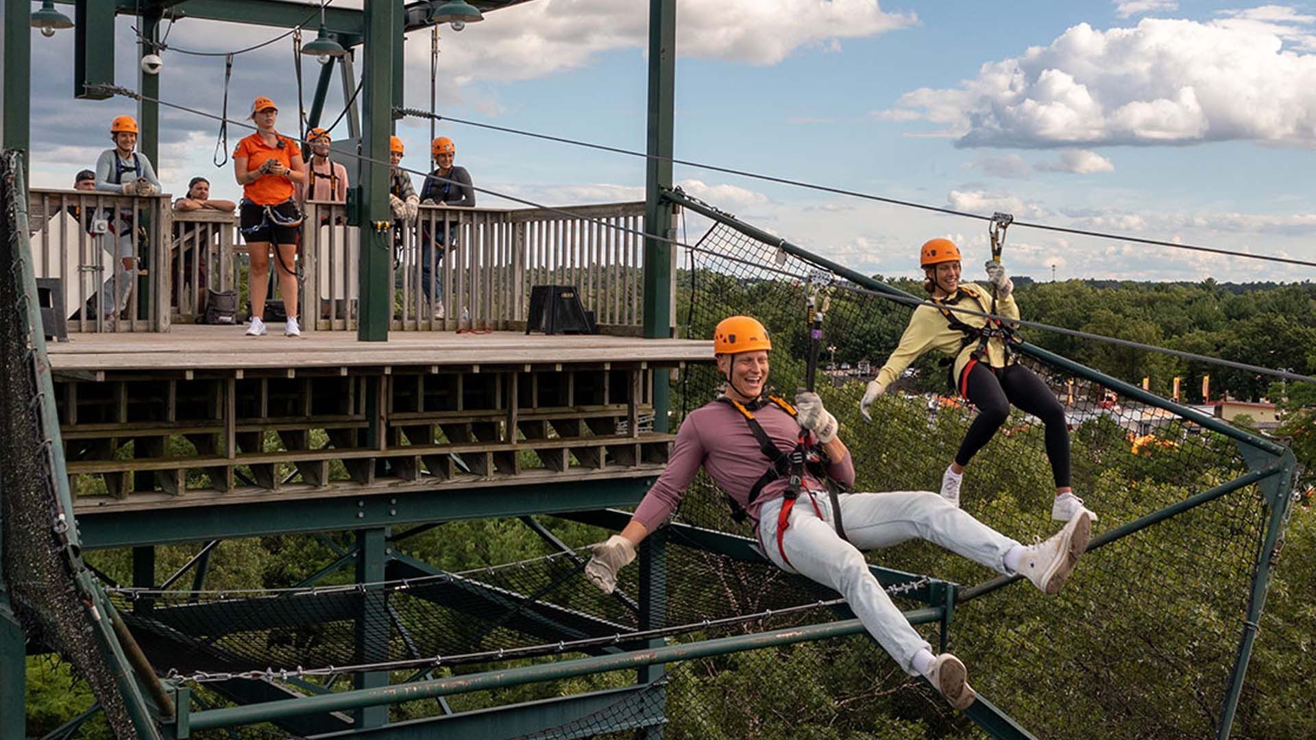 Thrill-seekers ziplining at Bigfoot Ropes Course in Wisconsin Dells, enjoying the adventure.