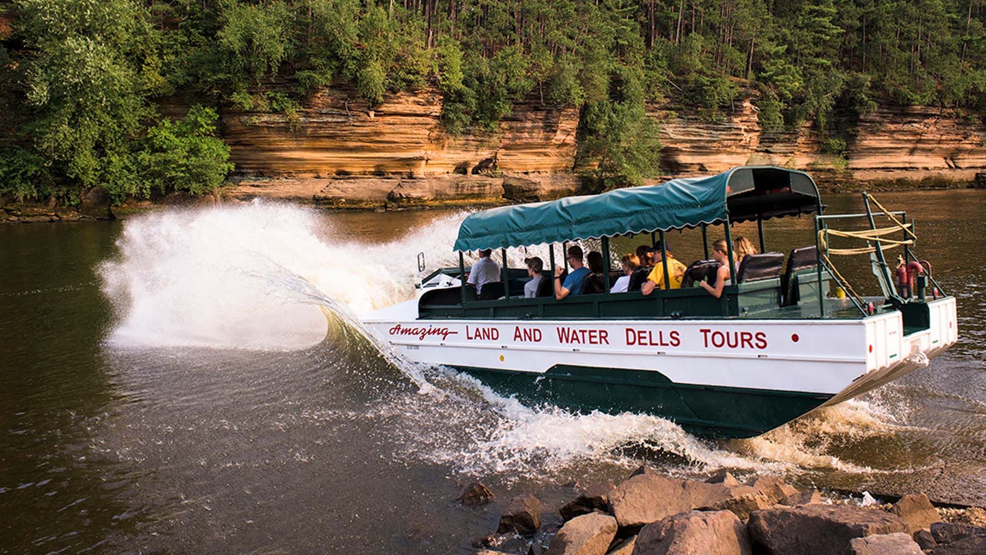Amphibious duck boat speeding through the water during a Wisconsin Dells Duck Tour.