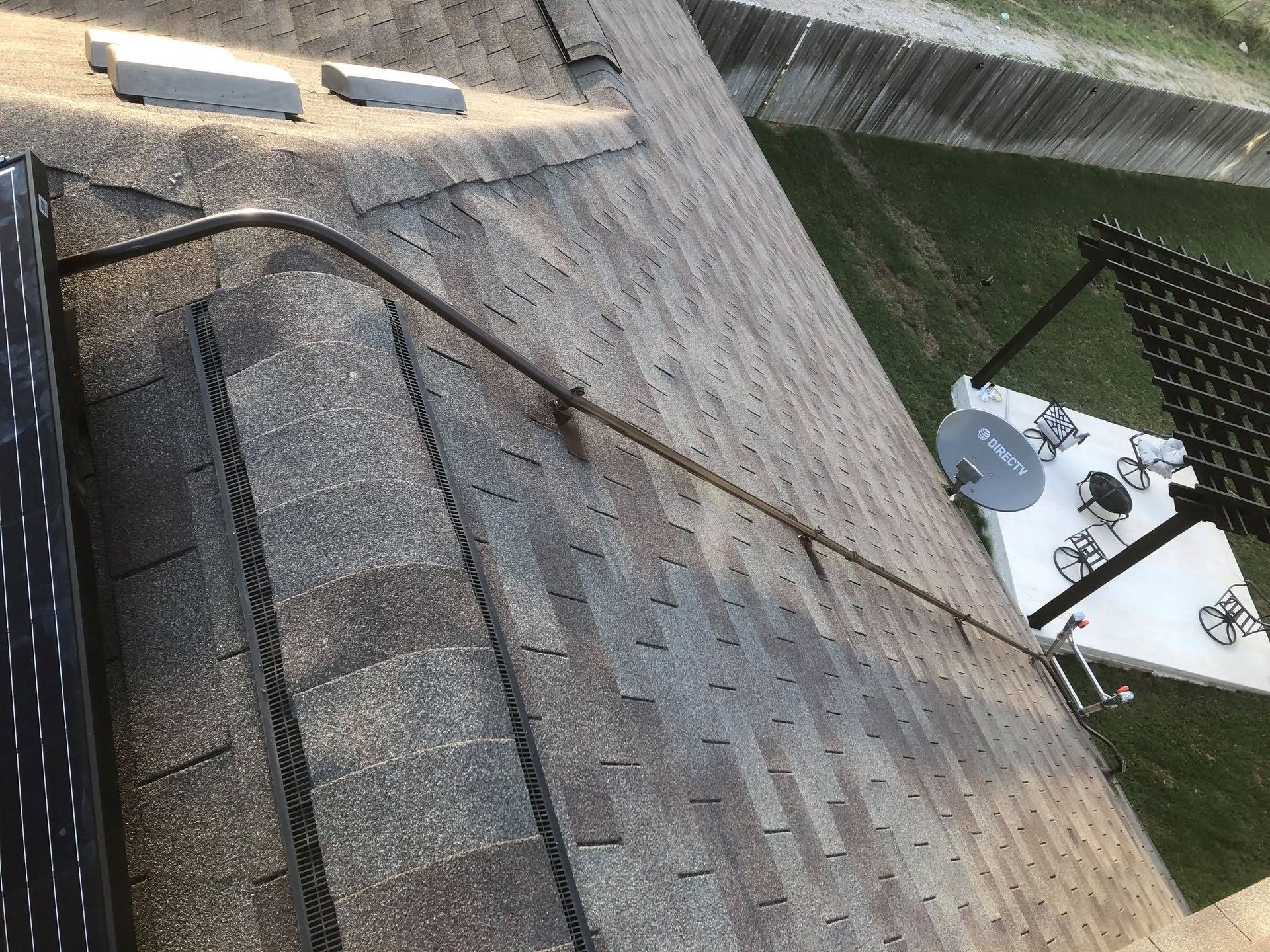 Roof shingles with damaged patches and rooftop HVAC units near the edge