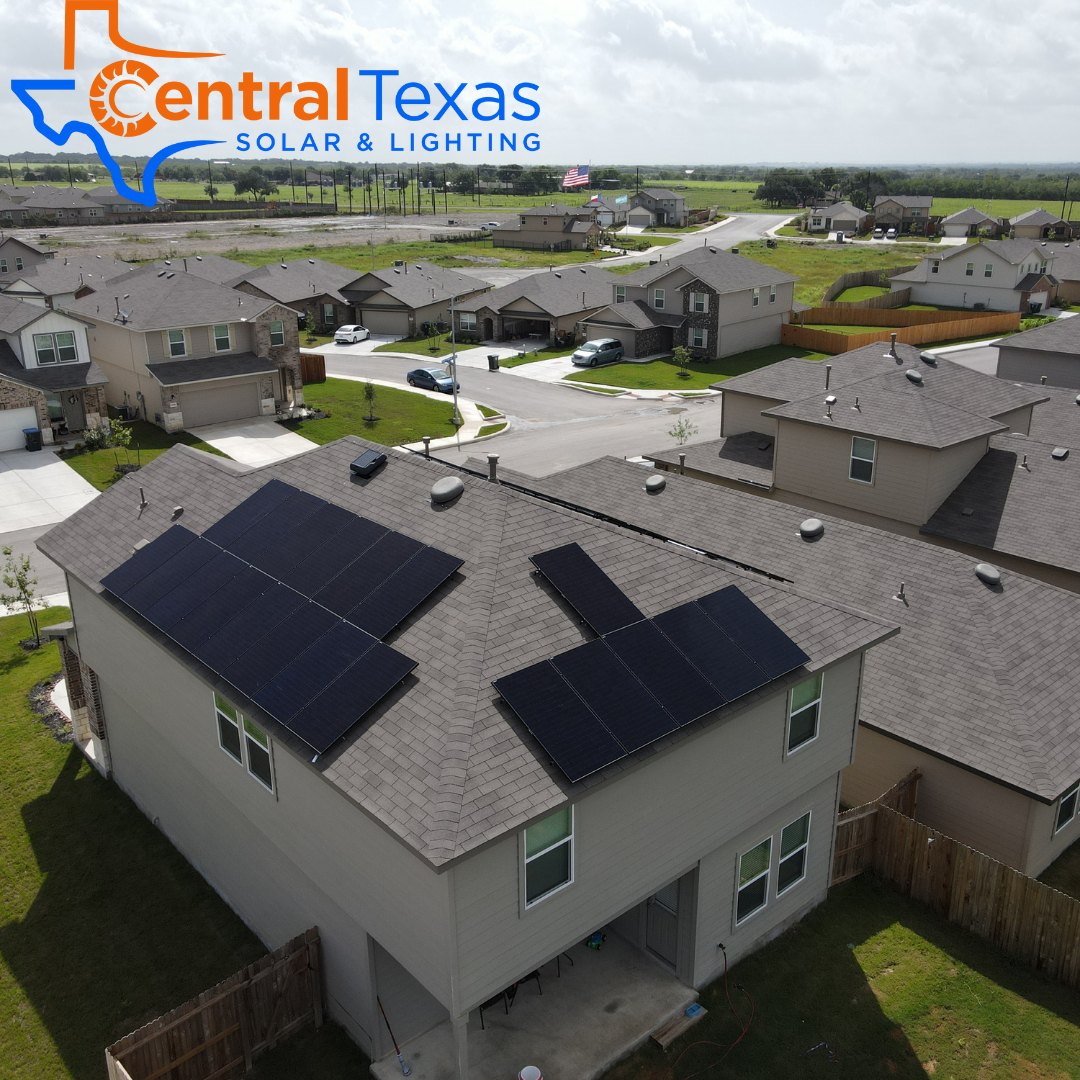 Suburban home with solar panels on the roof, aerial view, Central Texas Solar & Lighting logo