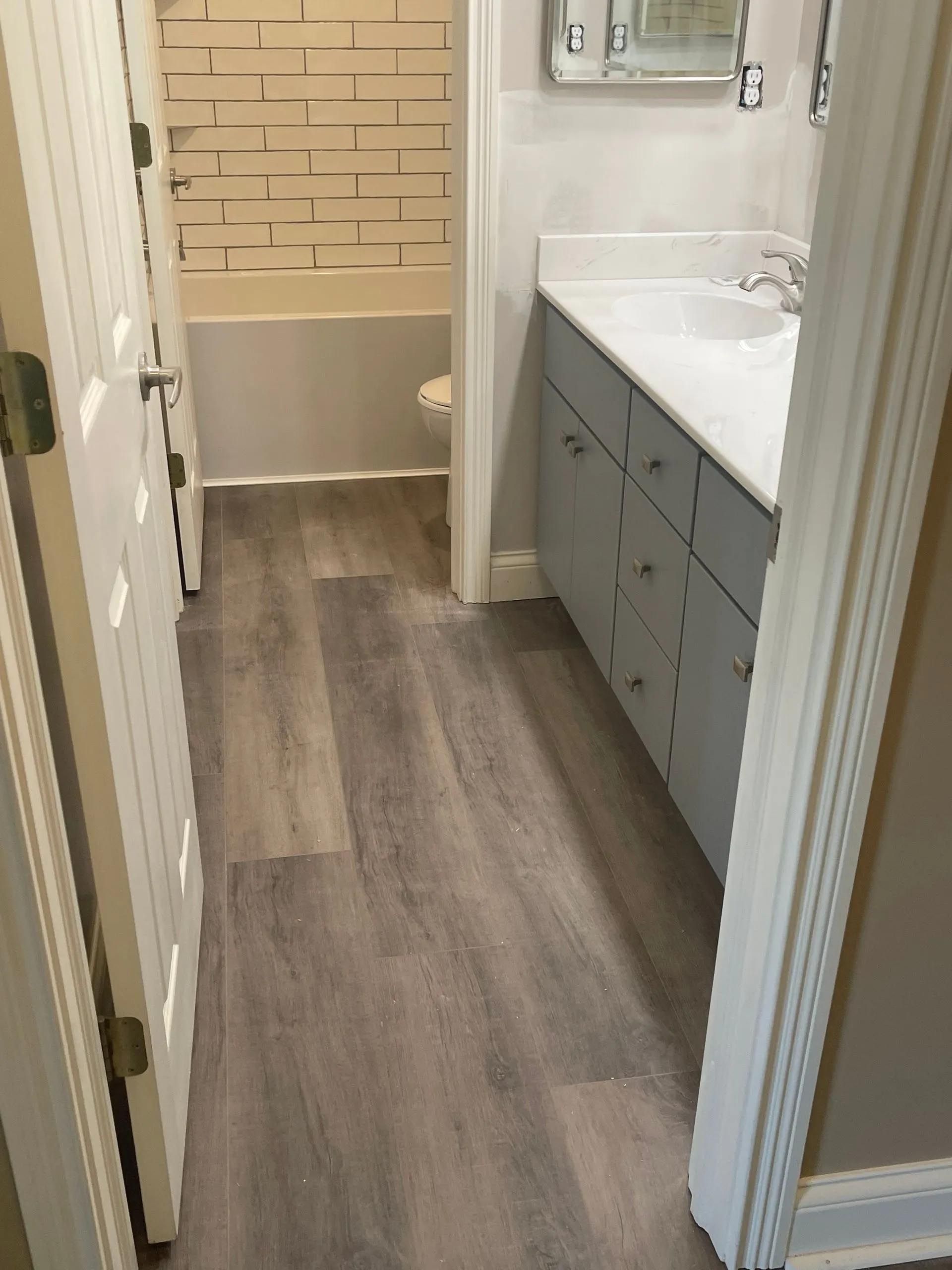 A bathroom with hardwood floors and a sink.
