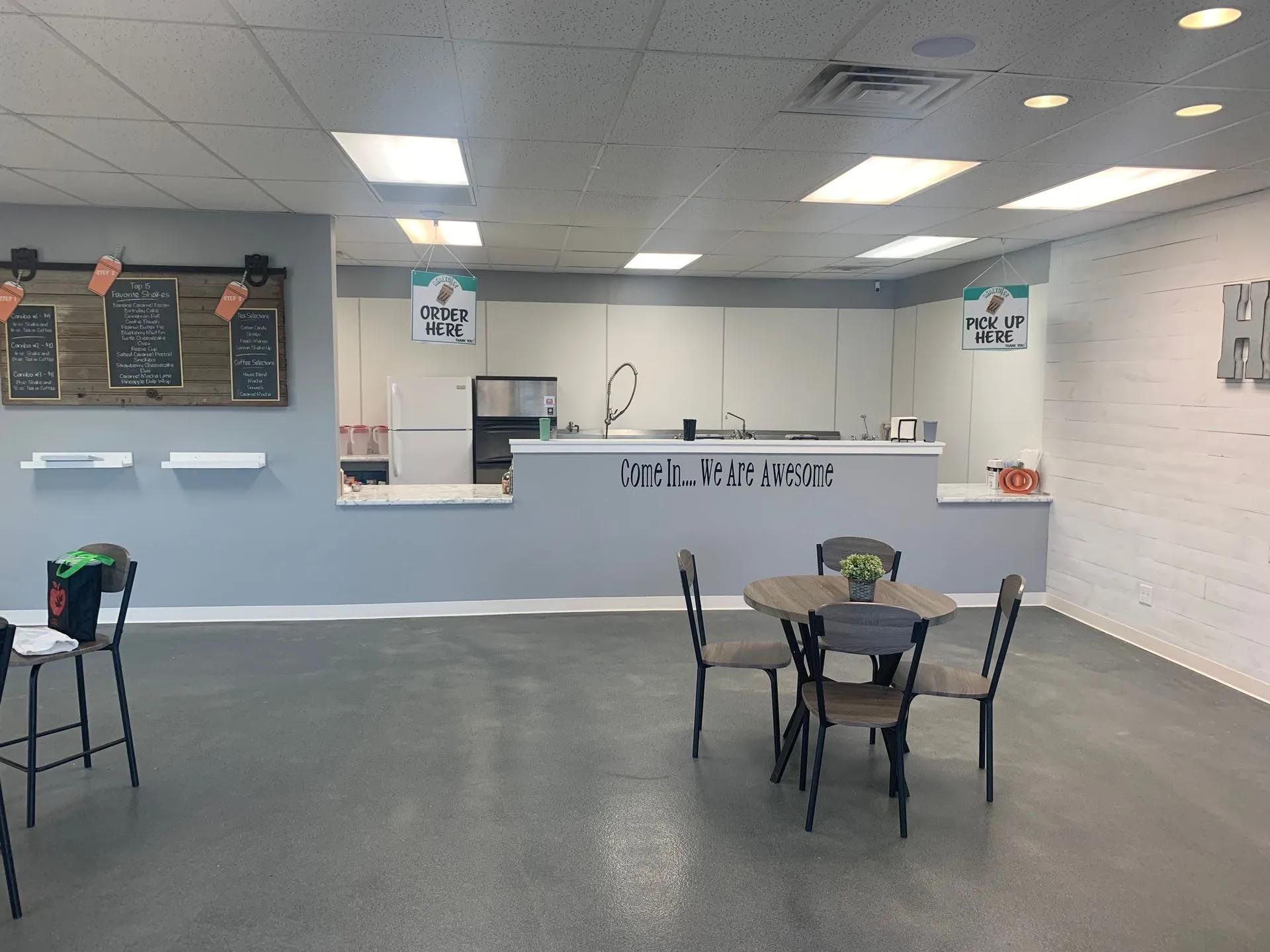 There is a table and chairs in the middle of the room.