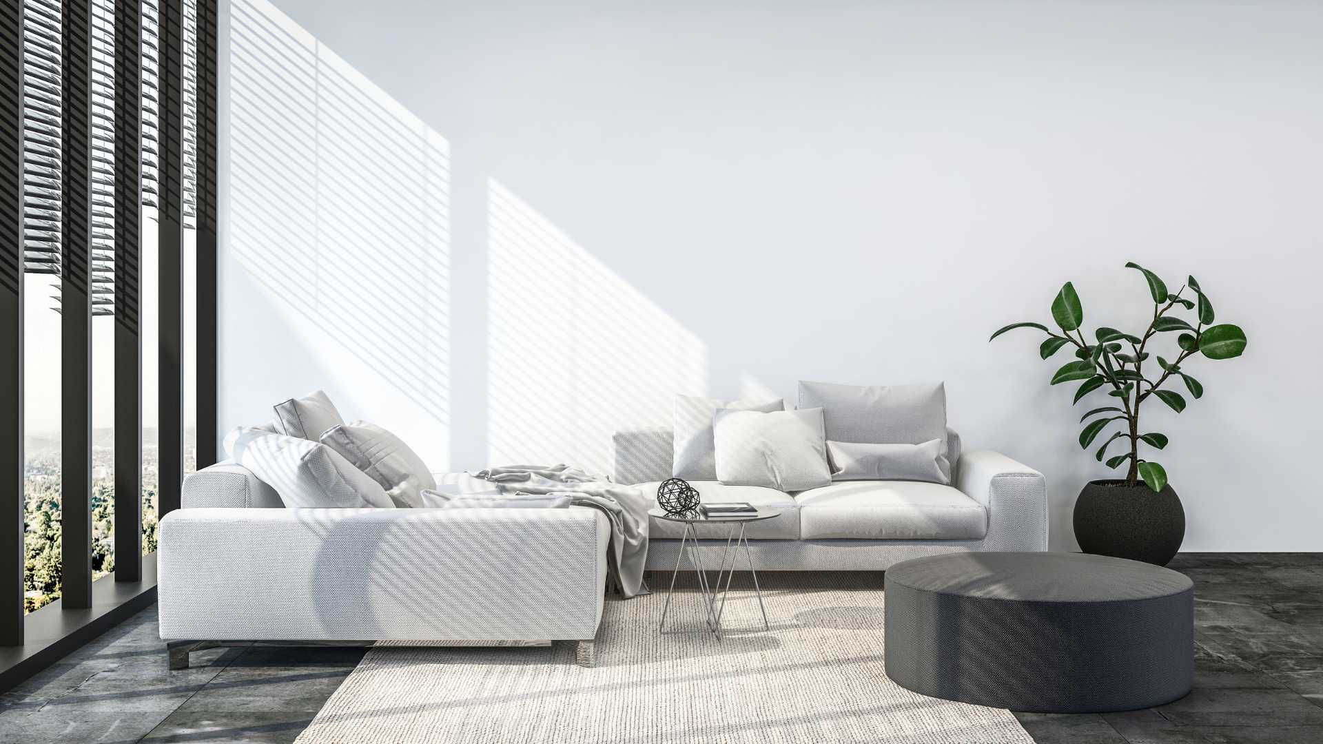 Modern living room with white sofa, plants, and large window with blinds.