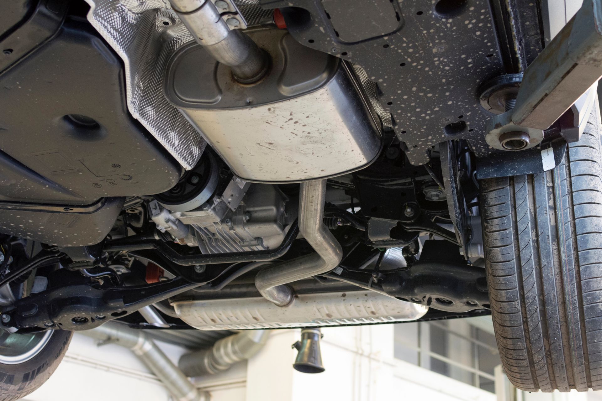 The underside of a car with the exhaust pipe visible