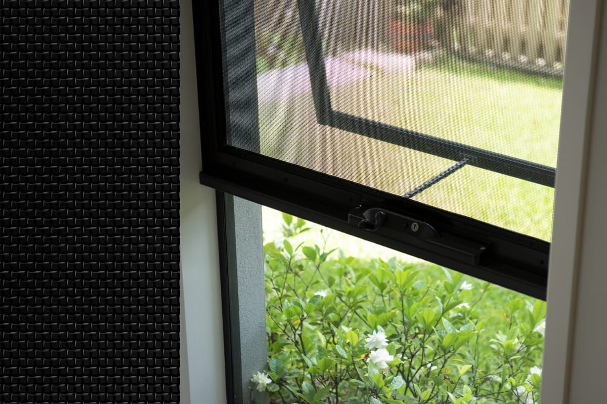 White window frame with handle and latch, screen in the open window.