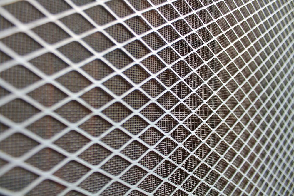 White diamond-patterned netting over a dark background.
