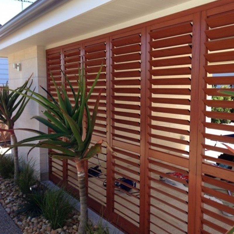 Gray roller shutter on a brick wall, under a gray eave.