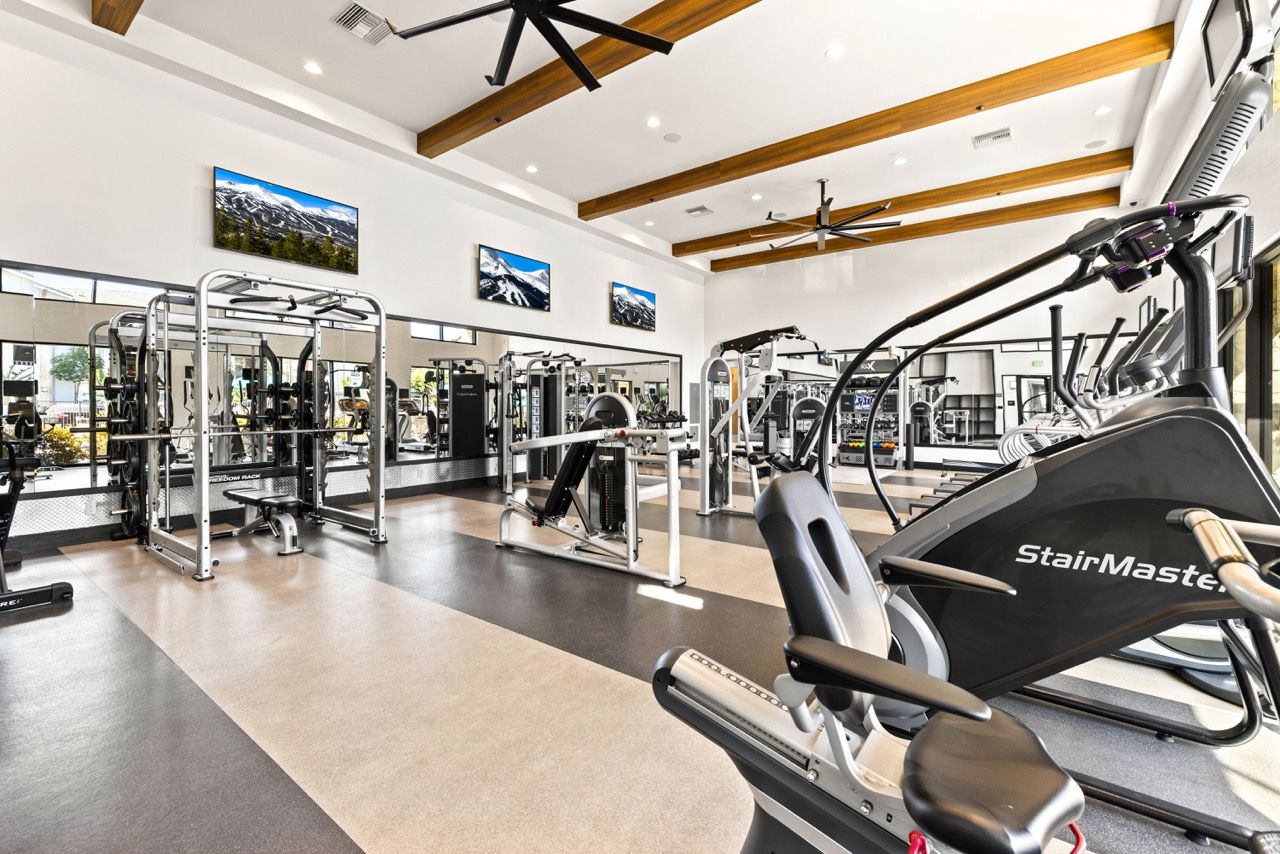 Spacious fitness center with cardio machines, strength equipment, and mirrors.