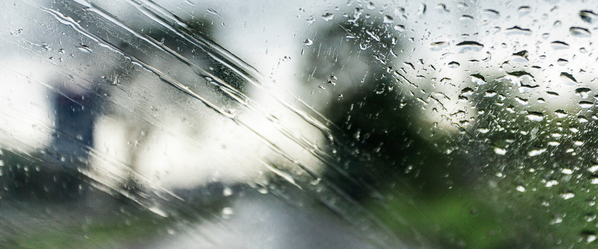 A close up of a window with rain drops on it