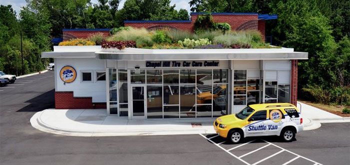 Chapel Hill Car Care Center with a green roof, yellow car out front.