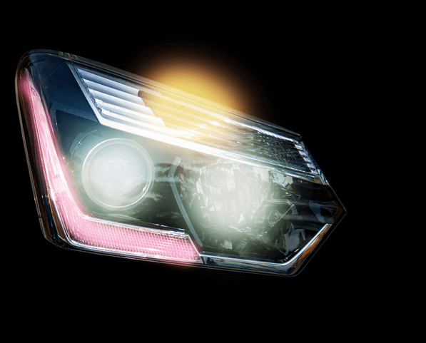 A close up of a car headlight with a yellow light coming out of it