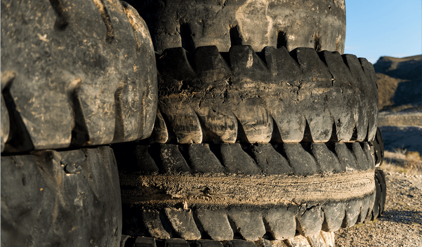 A pile of old tires are stacked on top of each other
