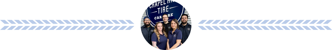 A group of people are posing for a photo. They are in front of a dark blue background.