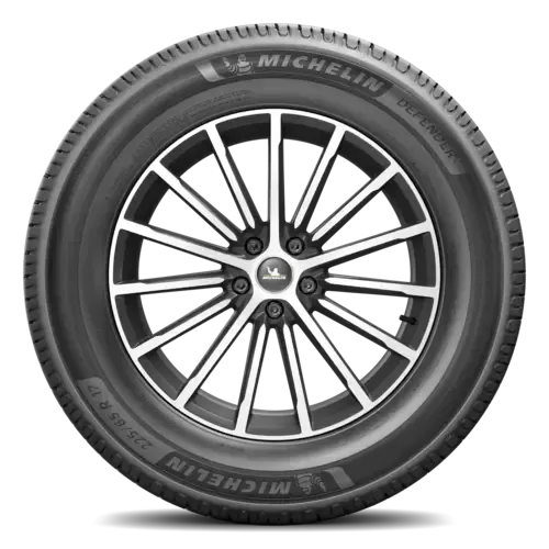 Michelin Defender tire on a black and silver alloy wheel; white background.