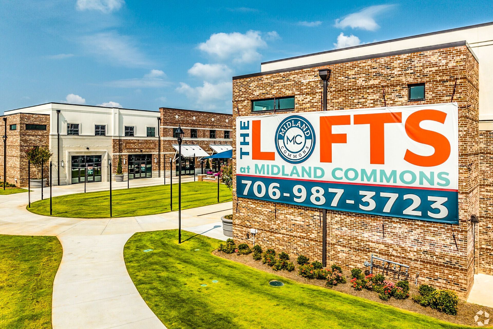 Elofts Midland Commons building sign with phone number at a brick office complex