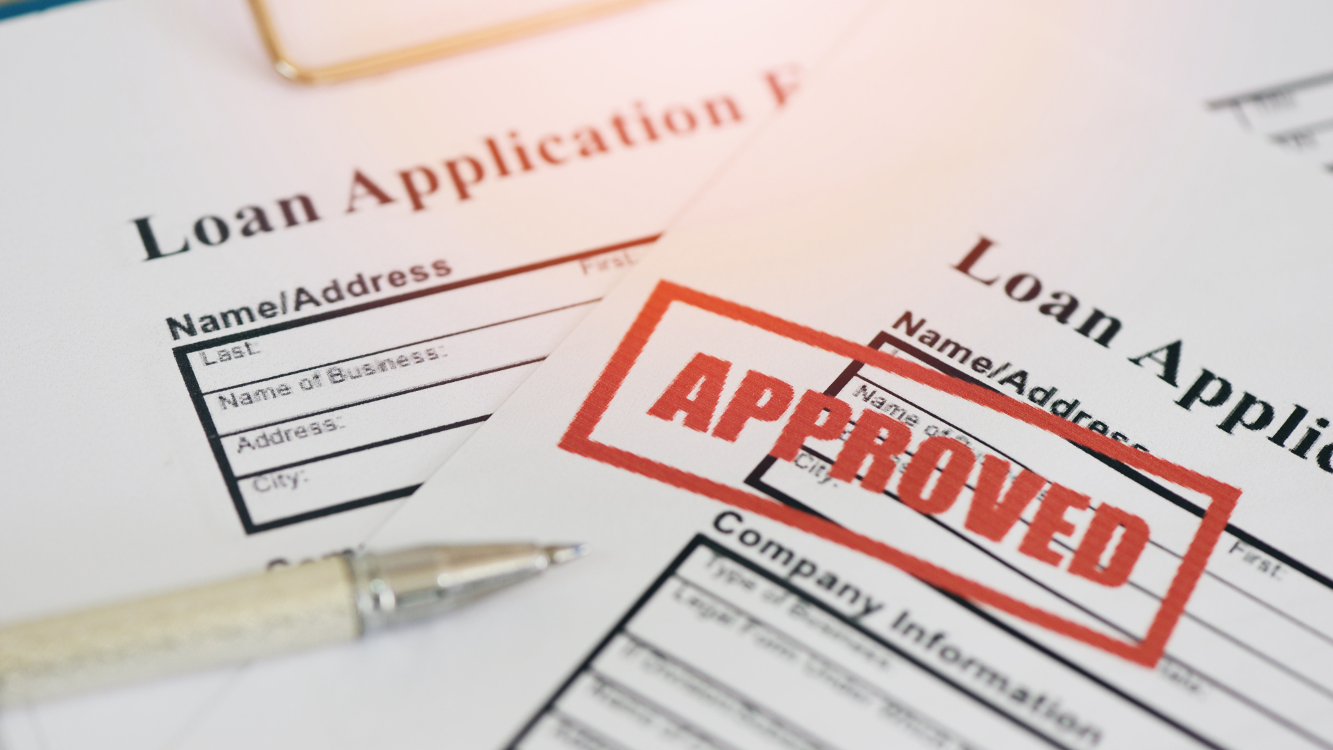 A loan application form with an approved stamp on it