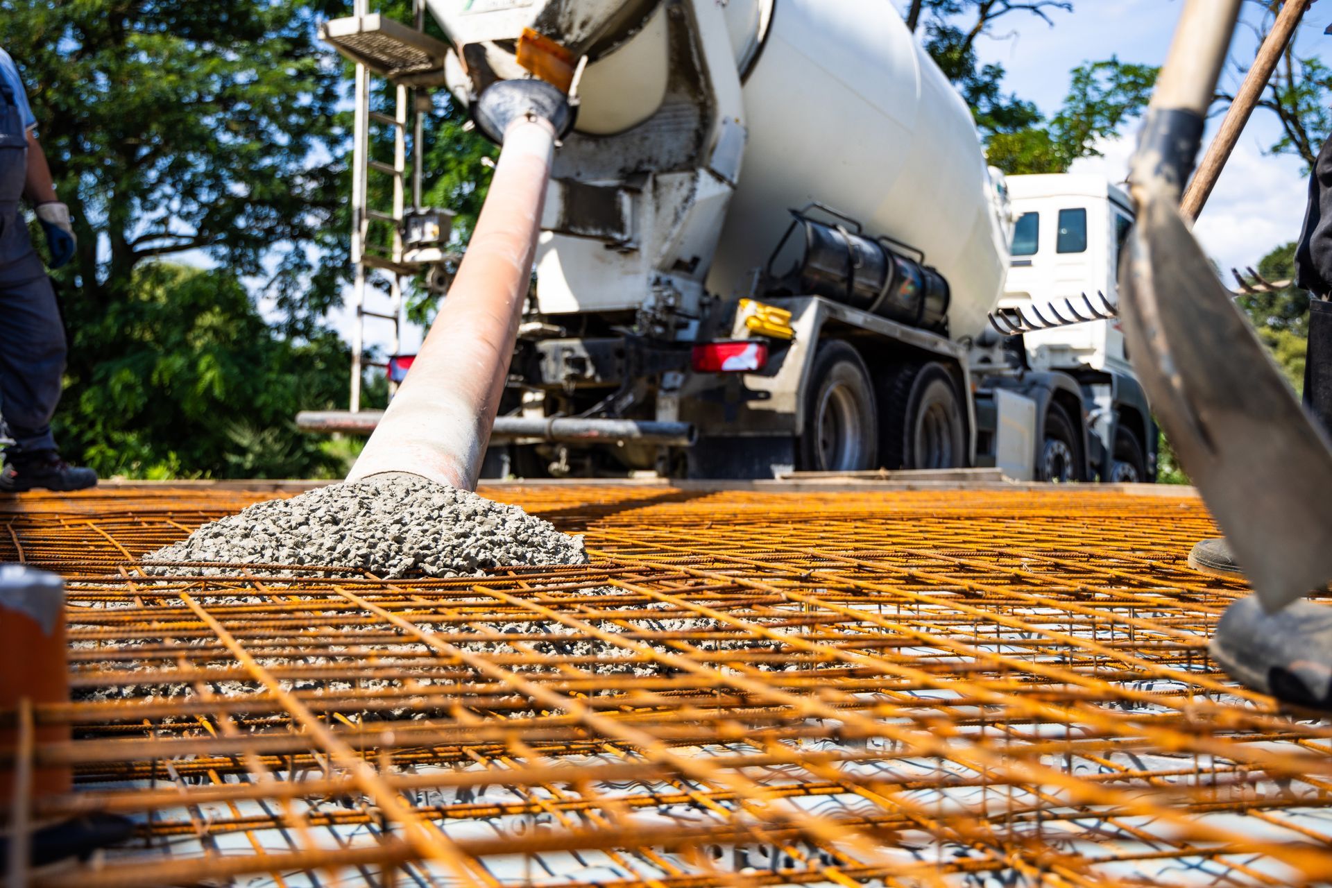 A concrete truck is pouring concrete on a construction site.