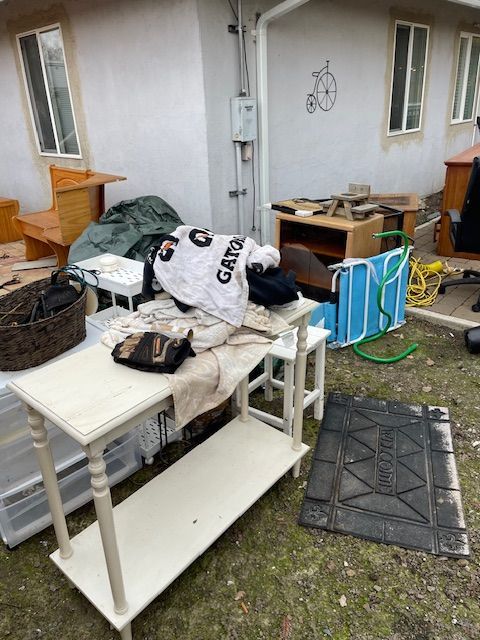 A gatorade shirt is sitting on top of a table in front of a house.