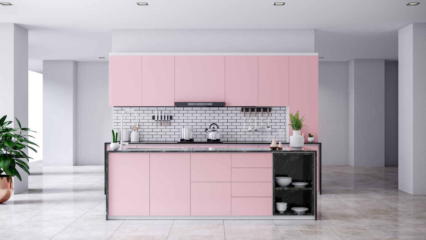 a kitchen with pink cabinets and a black counter top .